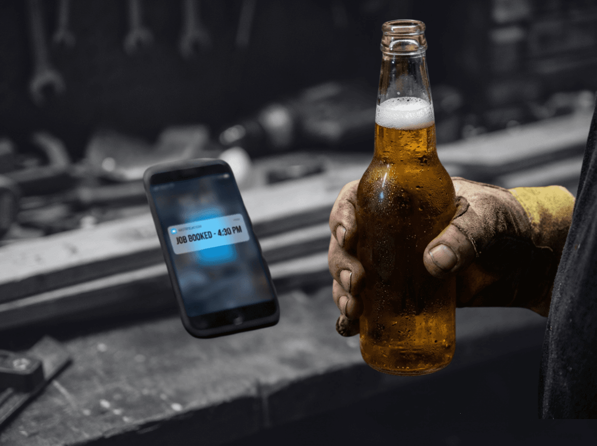 Tradesperson relaxing while phone shows job booked notification